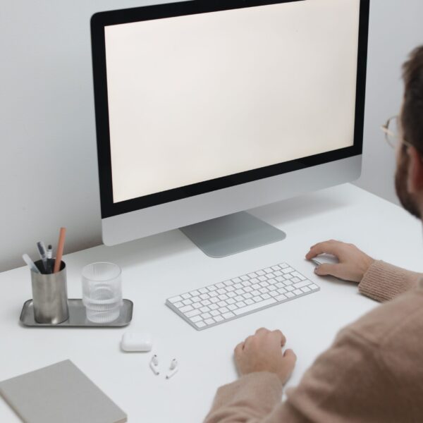 Free Crop man working on computer in workplace Stock Photo